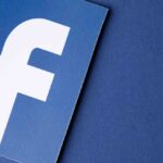 White Facebook logo on blue background